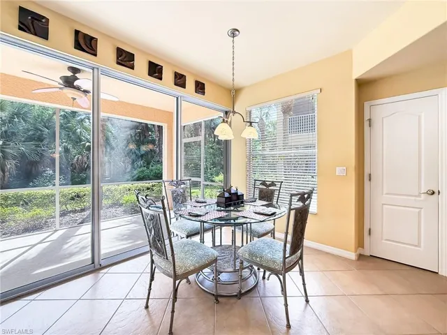 Dining area featuring a ceiling fan, baseboards, and light tile patterned floors
