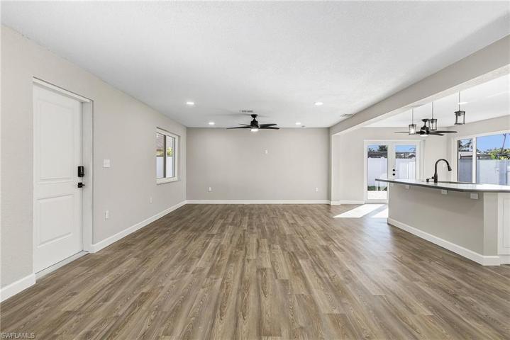 Looking toward the kitchen and dining area to the right background.