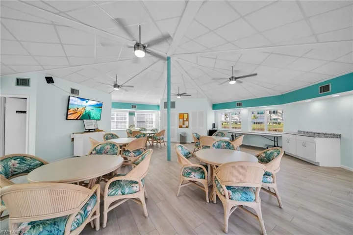 Dining area with light wood-style floors, lofted ceiling, and a drop ceiling