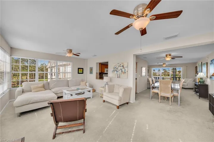 Living room with light carpet and ceiling fan