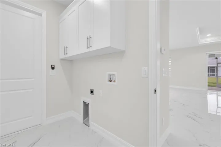 Washroom with cabinet space, light marble finish flooring, electric dryer hookup, hookup for a washing machine, and recessed lighting