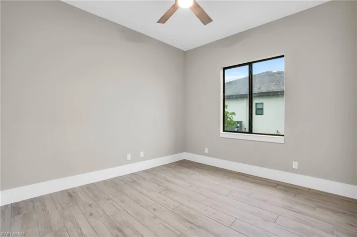 Empty room featuring light wood-type flooring and ceiling fan