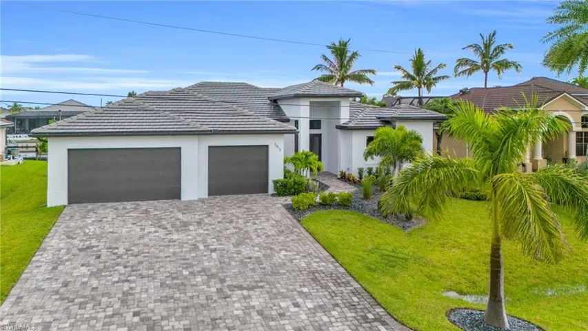 View of front of house with a front yard and a garage