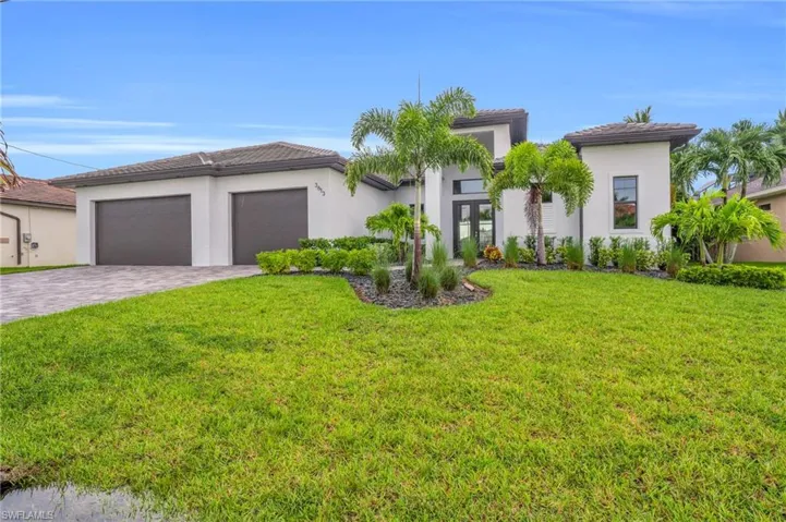 Mediterranean / spanish-style house featuring a front yard and a garage