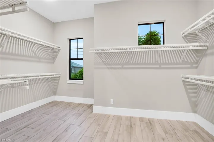 Spacious closet featuring hardwood / wood-style flooring