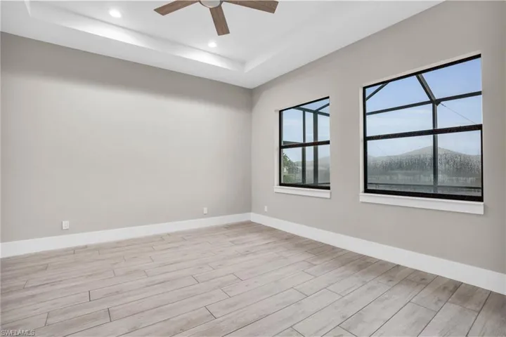 Spare room featuring light hardwood / wood-style flooring, a mountain view, and ceiling fan