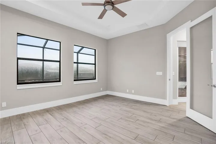 Spare room featuring light wood-type flooring and ceiling fan