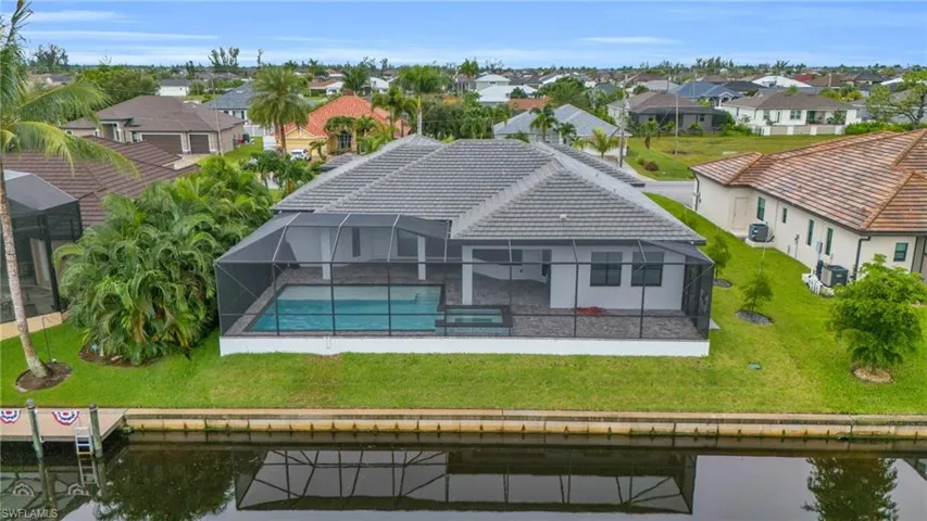 Birds eye view of property with a water view