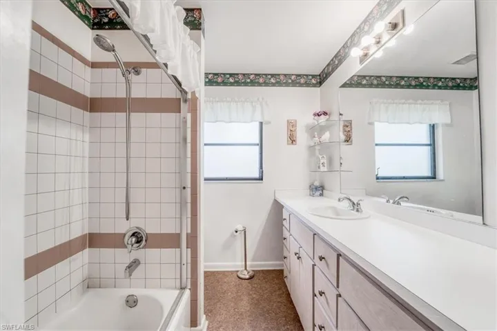 Bathroom featuring tiled shower / bath combo and vanity