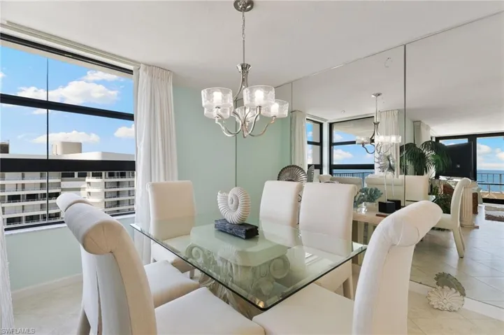 Separate dining area with strategically placed mirrored wall