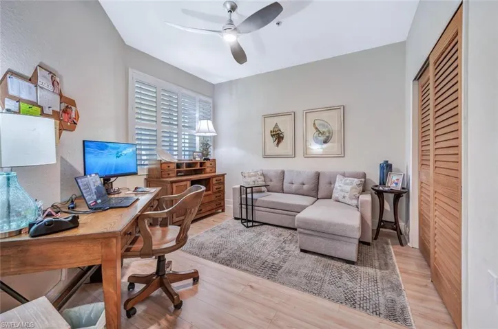 Office area with ceiling fan and light hardwood / wood-style flooring