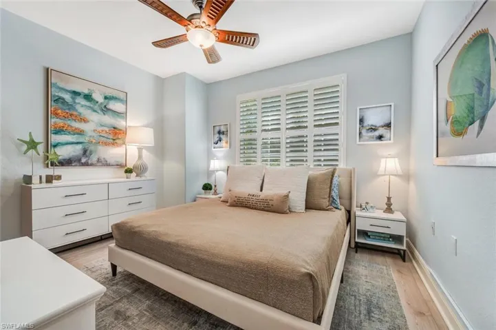Bedroom with ceiling fan and hardwood / wood-style flooring