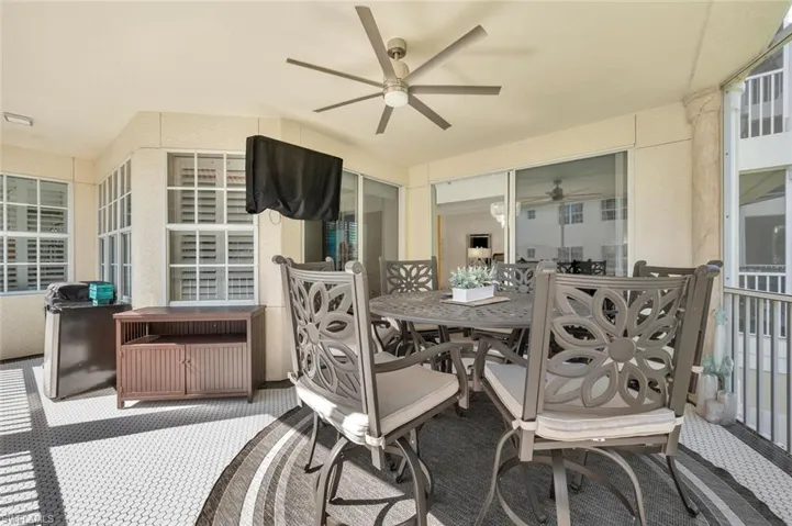 View of terrace with a hot tub and ceiling fan