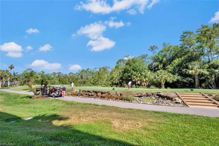View of home's community with a yard