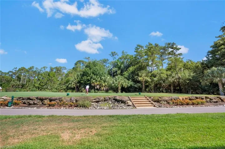 View of property's community with a lawn