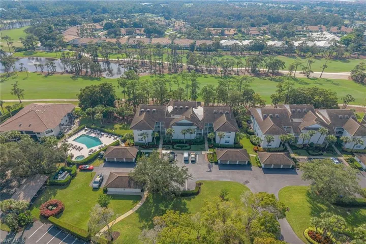 View of property location with a large body of water, a golf course, and nearby suburban area