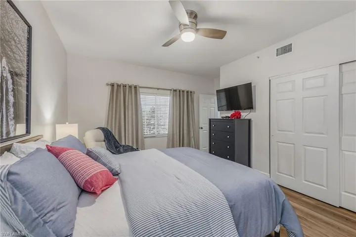 Bedroom featuring wood finished floors, a ceiling fan, and a closet