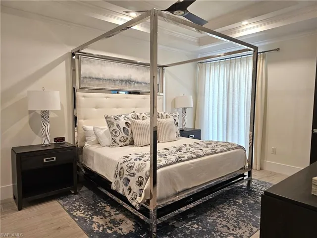 Bedroom with crown molding and light wood-style flooring