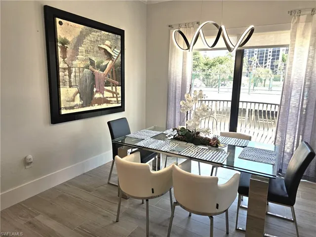 Dining space featuring wood finished floors and baseboards