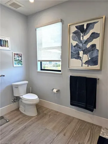 Bathroom featuring baseboards and light wood-style floors