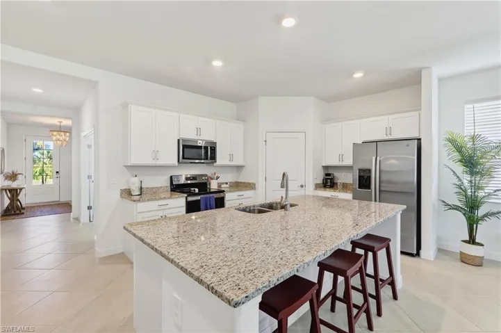 This kitchen layout gives you the choice of informal eating at the large center island or more of a sit down eating area in the dining room space