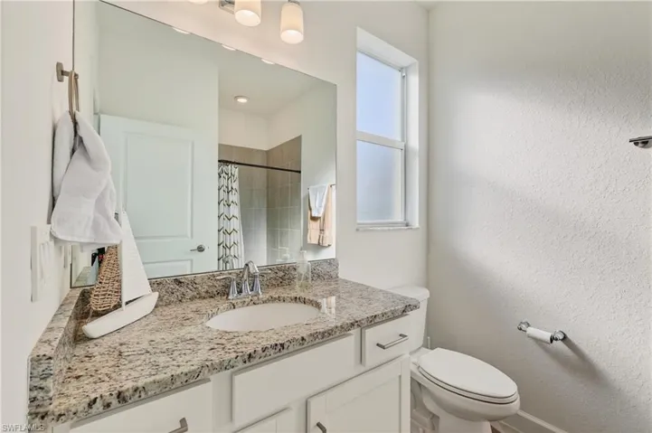 Full bathroom with vanity and a shower with curtain