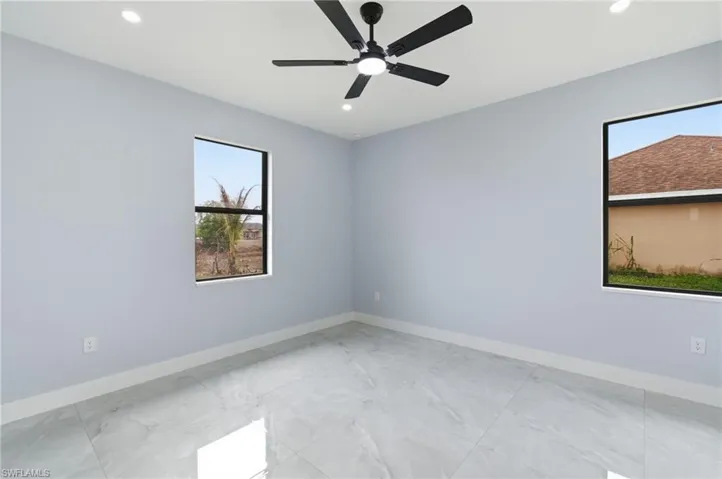 Unfurnished room with recessed lighting, ceiling fan, and light marble finish floors