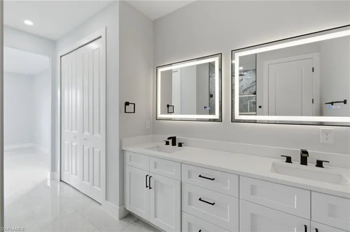 Bathroom with double vanity and a closet