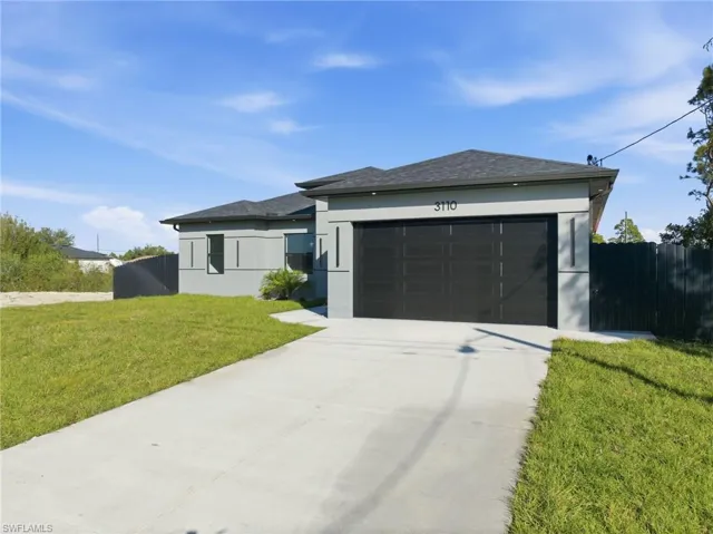 View of front of home featuring driveway, stucco siding, a garage, and roof with shingles