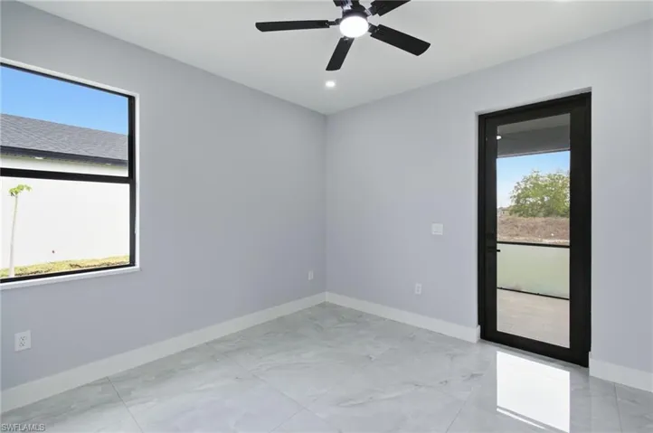Unfurnished room featuring a ceiling fan, light marble finish flooring, and recessed lighting