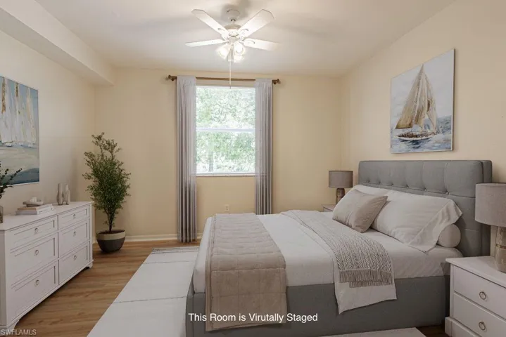 Bedroom featuring light wood-type flooring and a ceiling fan