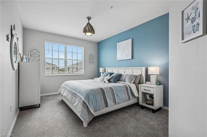 Carpeted bedroom with baseboards