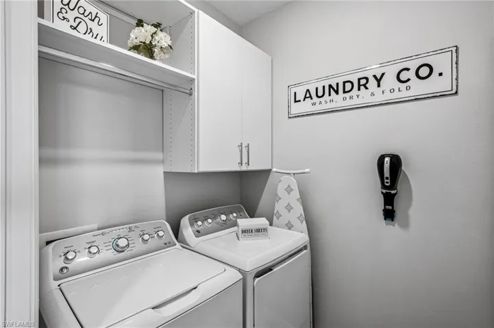 Washroom with cabinet space and independent washer and dryer