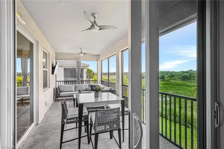 Sunroom with a ceiling fan and an outdoor living space