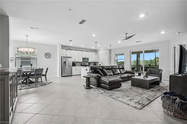 Living area with a chandelier, light tile patterned floors, and recessed lighting