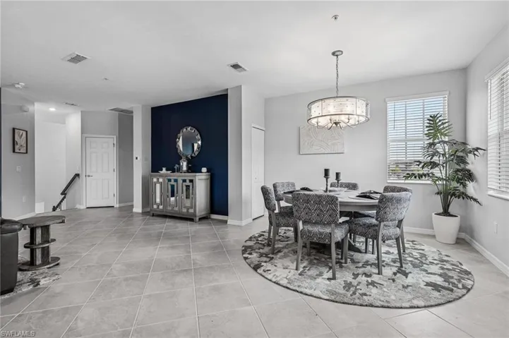 Dining room featuring a chandelier and light tile patterned floors