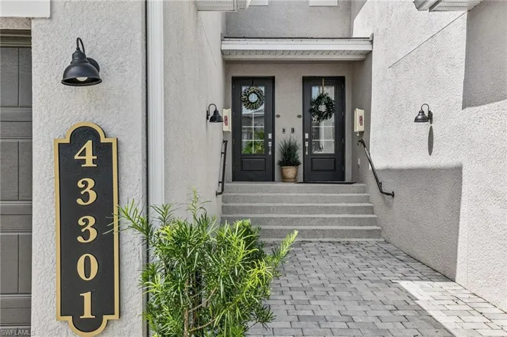 Doorway to property featuring stucco siding