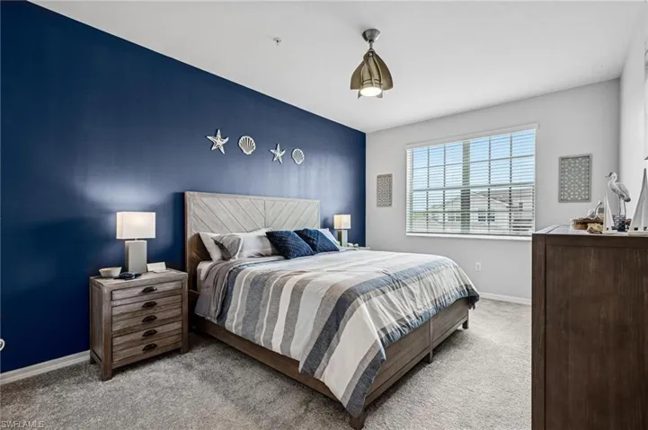Bedroom featuring carpet flooring and baseboards