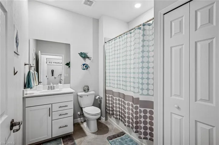 Bathroom featuring vanity, tile patterned flooring, and a shower with curtain