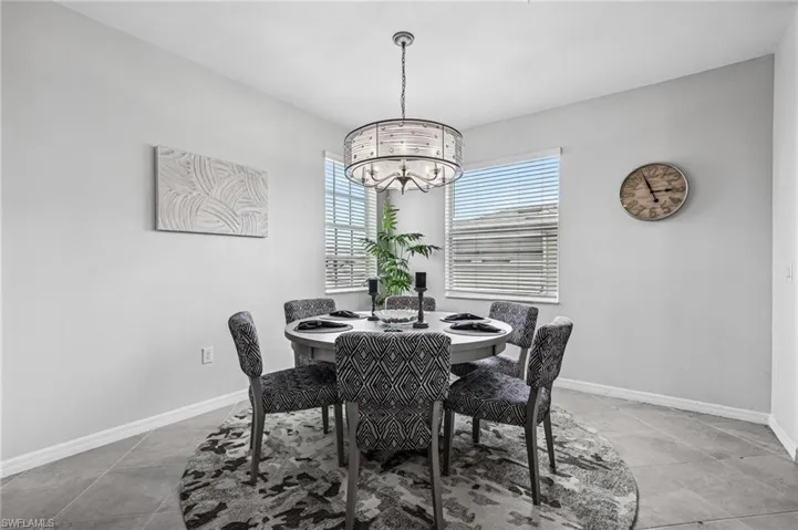 Dining area featuring a chandelier and light tile patterned floors