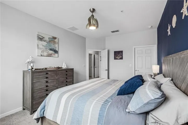 Bedroom featuring light colored carpet and baseboards