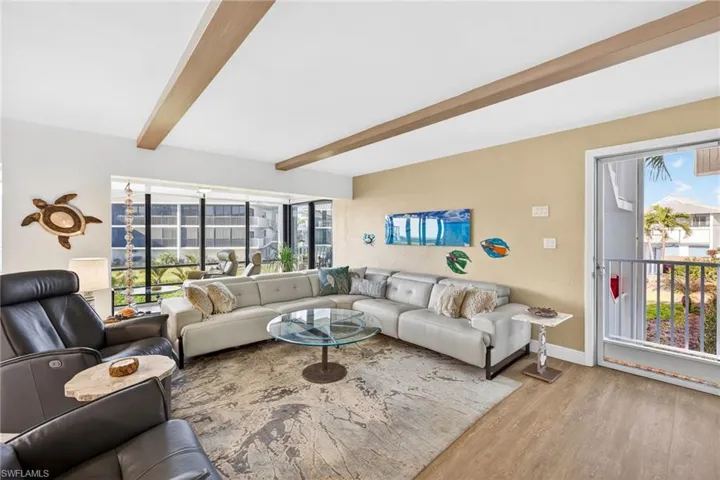 Living room featuring beam ceiling and light wood-type flooring