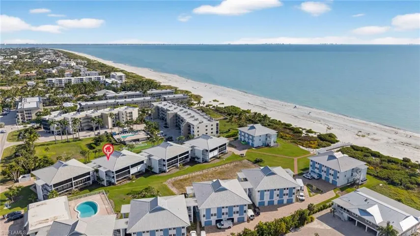 Bird's eye view of unending shoreline and apartment complex / building