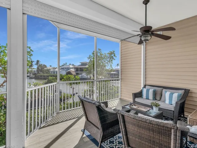 Sunroom with a water view and ceiling fan
