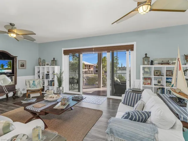 Living room featuring hardwood / wood-style floors and ceiling fan