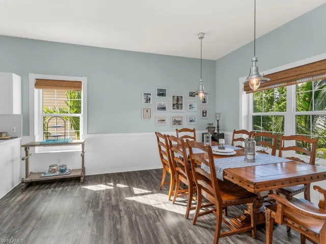 Dining area with dark hardwood / wood-style floors