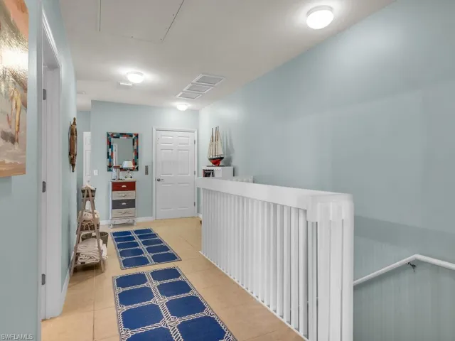 Hallway with light tile patterned flooring