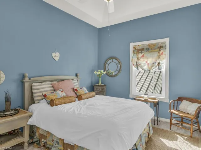 Bedroom with hardwood / wood-style floors and ceiling fan