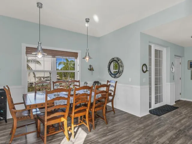 Dining space with dark hardwood / wood-style floors