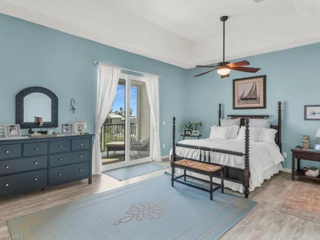 Bedroom with access to exterior, light hardwood / wood-style flooring, and ceiling fan